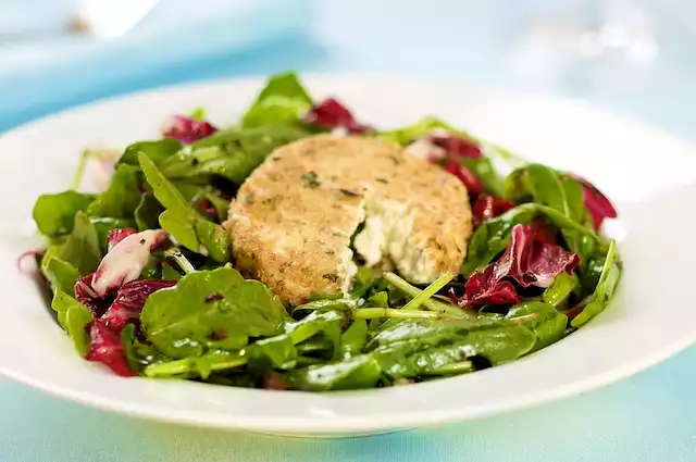 Arugula Salad Warm Goat Cheese with Black Olive Vinaigrette